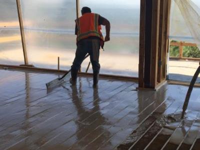 Gypsum being installed over radiant heating
